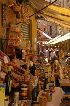 an outdoor market with lots of food on display