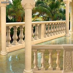 an ornate balcony with columns and railings in front of palm trees on the other side