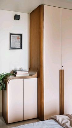 a bed room with a neatly made bed and cupboards