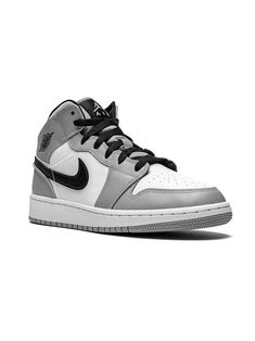 Light smoke grey/black/white leather Air Jordan 1 Mid sneakers from NIKE KIDS featuring round toe, flat rubber sole, front lace-up fastening, branded insole and signature Swoosh logo detail. These styles are supplied by a premium sneaker marketplace. Stocking only the most sought-after footwear, they source and curate some of the most hard to find sneakers from around the world. | Jordan Kids Air Jordan 1 Mid sneakers Snicker Shoes, Nike Shoes For Boys, Pretty Sneakers, Mid Sneakers, Shoes For Boys, Best Shoes For Men, Nike Air Jordans, Best Running Shoes, Grey Sneakers