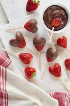 chocolate covered strawberries on skewers with dipping sauce