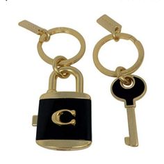 two key chains with the letter c on them and a lock attached to each other