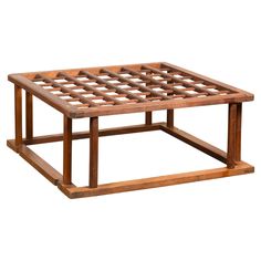 a coffee table made out of wood with lattices on the top and bottom part