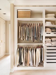 an organized closet with clothes and baskets