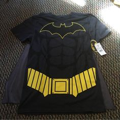 Nwt Batman Shirt With Velcro Cape. Perfect For Halloween! Comes From A Smoke Free And A Pet Free Home. Casual Yellow Top For Halloween, Black Tops For Comic-con Fan Conventions, Black Tops For Comic-con, Black Fandom Shirt For Fan Conventions, Black Shirt With Character Print For Cosplay, Halloween Cosplay Top With Character Print, Halloween Cosplay Tops With Character Print, Character Print Tops For Halloween Cosplay, Themed Black Shirt With Character Print