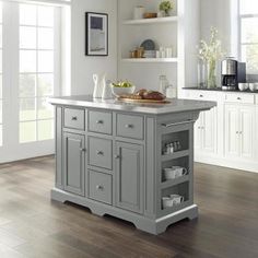 a kitchen island with two open shelves on each side