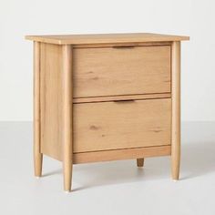 a wooden nightstand with two drawers on one side and an open drawer on the other