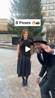 a man in a suit and hat standing next to a woman wearing a black dress