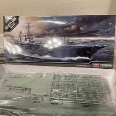 a box with a model ship in it