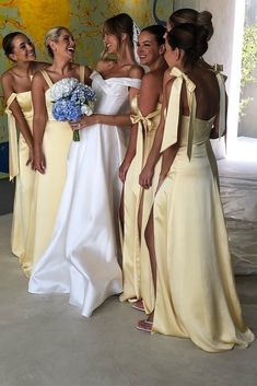 the bridesmaids are all dressed in yellow dresses