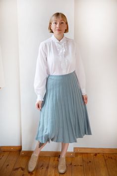 This vintage pleated A-line skirt in light-washed blue boasts timeless elegance. Crafted from high-quality fabric with a comfortable lining, it features a stretchy waist for the perfect fit. Perfect for both casual and dressy occasions, it's a versatile addition to any wardrobe. MEASUREMENTS -Model usually wears size M and is 168 height. -Length: 73 cm / 28.7 inch -Waist: 32 cm / 12.5 inch -Waist, when stretched fully: 46 cm / 18.1 inch Condition:  excellent vintage condition Please note that th Classic Cotton Pleated Skirt With Accordion Pleats, Classic Blue Pleated Skirt For Spring, Classic Cotton Pleated Lined Skirt, Classic Full Pleated Skirt, Fitted Accordion Pleats Daywear Skirt, Fitted Accordion Pleated Skirt For Daywear, Fitted Accordion Pleats Pleated Skirt For Daywear, Classic Spring Pleated Skirt With Accordion Pleats, Classic Tiered Skirt For Spring