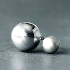 Ball collection was created for women who like the simple and geometric form. This modern and minimalist, adjustable ring was made from sterling silver. The bigest orb is polished and make interesting contrast to the smaller, matte one. It's geometric form is timeless. Ideal for women who prefer minimal, avant garde, contemporary jewelry. Diameter of orbs: 24 mm, 14 mm Enjoy colorful world of Shambala A few words about our works: All of the products in gallery are designed by us. Our studio is l Open Ball Ring, Silver Blob Ring, Modern Single Sphere Earring, Unique Silver Orb-shaped Jewelry, Minimalist Sterling Silver Sphere Earrings, Motifs Art Nouveau, Chunky Silver Rings, Modernist Ring, Open Cuff Bracelet