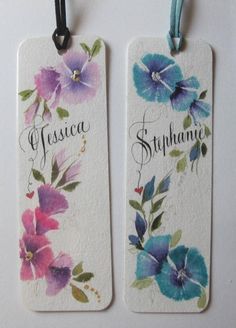 two tags with flowers painted on them