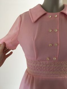 "1970's pink polyester mini dress. Several discolored spots through out the dress (see photos) Size XS in womens Measurements: B: 34\" W: 26\" H: 38\" Shoulder to top of band: 11.5\" Band height: 3\" Bottom of band to hem: Sleeve length: 7.5\"" Vintage Pink A-line Dress, Pink Mini Vintage Dress For Spring, Retro Pink A-line Mini Dress, Retro Pink A-line Dress, Pink A-line Dress With Buttons, Vintage Pink Mini Length Dress, Vintage Knee-length Pink Dress, Vintage Pink Knee-length Dress, Pink Vintage Knee-length Dress