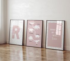 three framed children's art prints on the floor