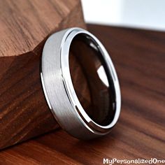 a wedding ring sitting on top of a wooden block