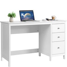 a laptop computer sitting on top of a white desk next to a potted plant