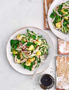 two white plates filled with food next to each other