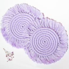 two circular purple rugs on top of each other