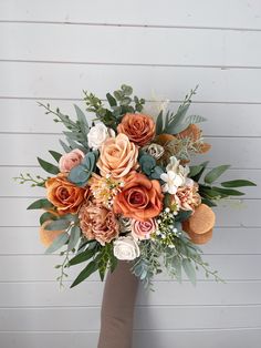 a bridal bouquet with orange and white flowers