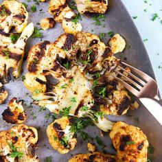 grilled cauliflower on a pan with a fork