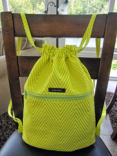 a yellow bag sitting on top of a wooden chair