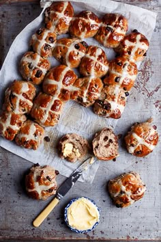 hot cross buns and butter on a baking sheet