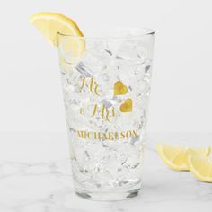 a close up of a glass with ice and lemon slices