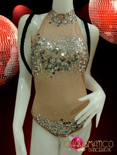 a mannequin dressed in a gold and silver outfit with sequins on it