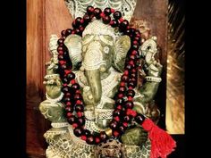 an elephant statue is adorned with red beads