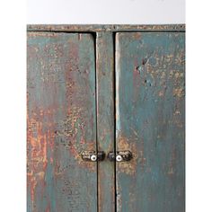 an old blue cabinet with rusted paint on it's doors and handlebars