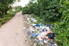 trash on the side of a dirt road