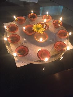 a cake with lit candles in it on a table