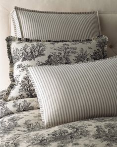 the pillows are lined up against the headboard in this bedding set with toiler designs