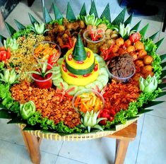 a platter filled with lots of food on top of a table