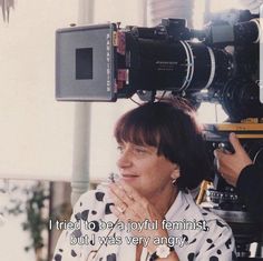 a woman sitting in front of a camera