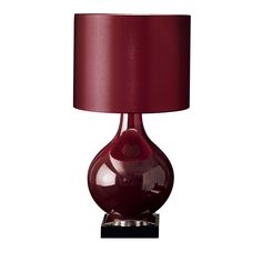 a table lamp with a red shade on the base and a white light behind it