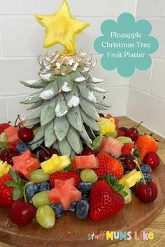 the pineapple christmas tree fruit platter is made with fresh berries, strawberries, melon, and pineapples