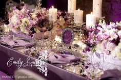 the table is set with candles, flowers and plates for an elegant dinner party or wedding reception