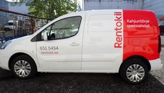 a red and white van parked on the street