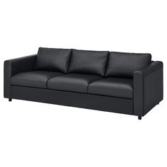 a black leather couch with four pillows on it's back end and arms, viewed from the front