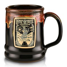 a brown and black coffee mug with an image on it