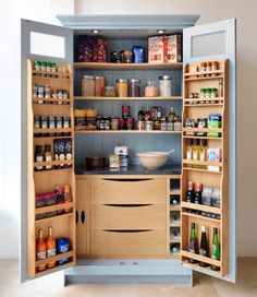 an open pantry with lots of spices and condiments on the shelves in it