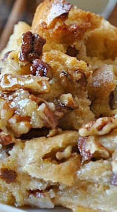 a close up of a plate of food with bread and nuts on it's side