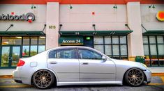 a silver car parked in front of a building