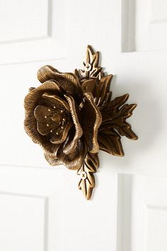 a close up of a door handle with a flower on it's center piece