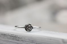 a rose ring sitting on top of a wooden table