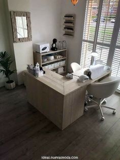 a room with a desk, chair and window in the corner that has shutters on both sides