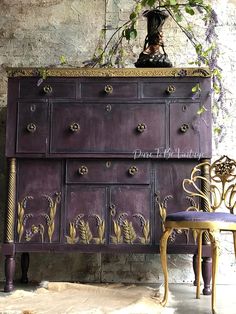 an old dresser has been painted purple and gold