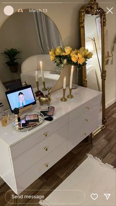 a white dresser topped with lots of drawers next to a mirror